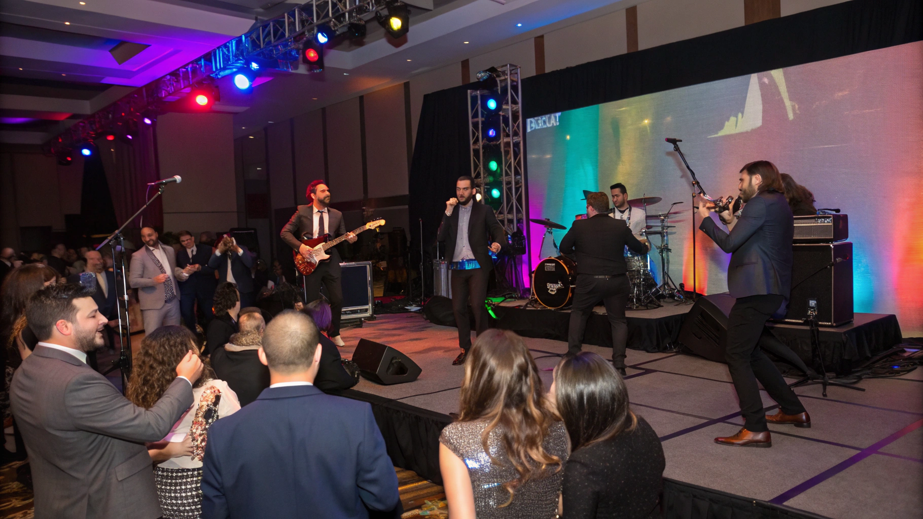 AI generated image by Red Panda AI: Rock band playing at a corporate event. Audience is dressed in business clothes, having fun, dancing 