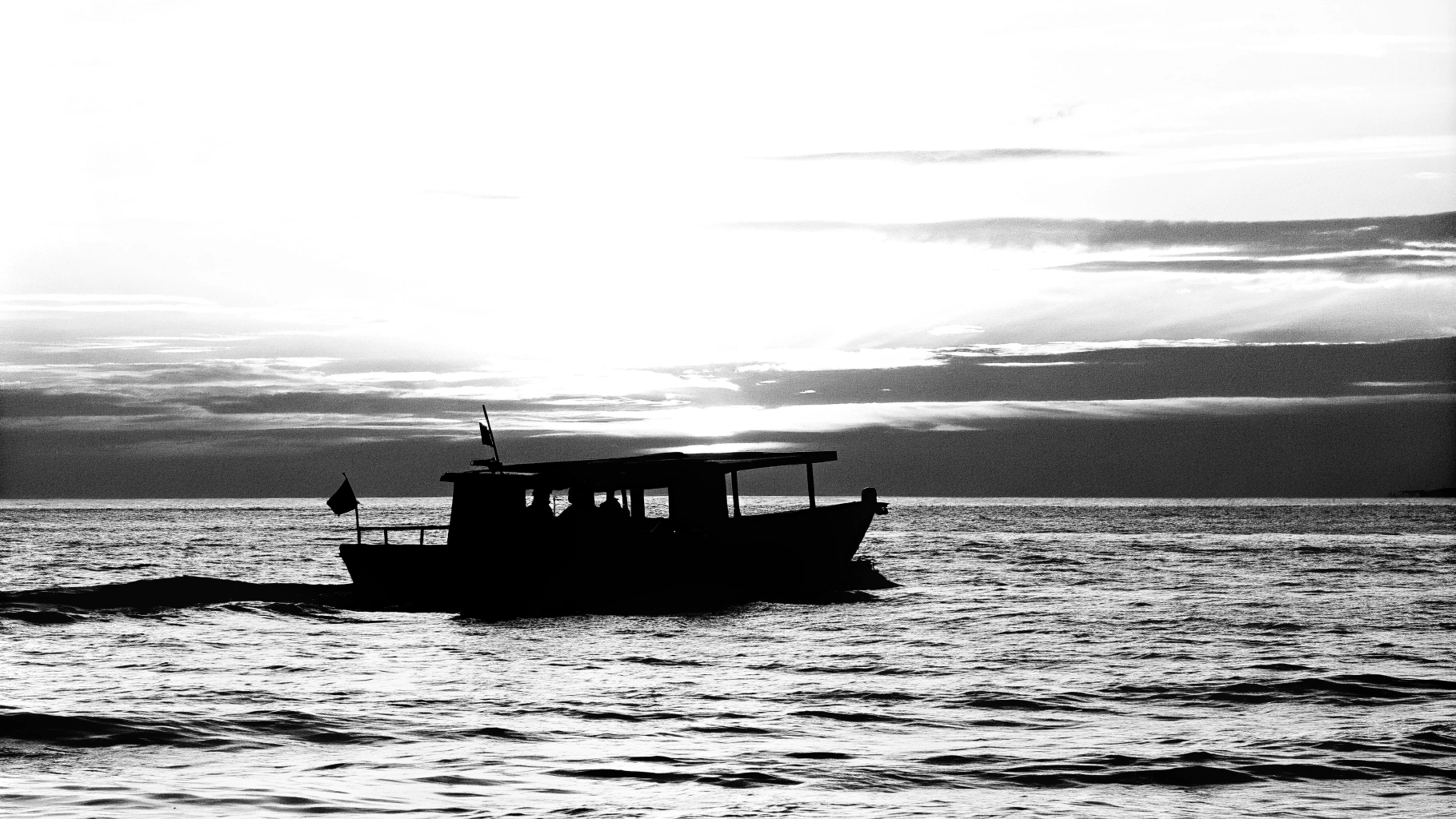 AI generated image by Red Panda AI: a boat on the ocean with a sunset in the background 