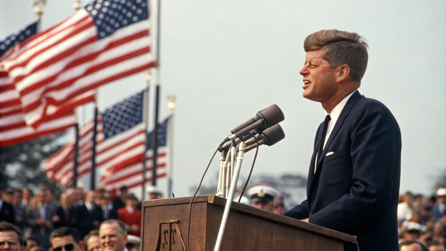 AI generated image by Red Panda AI: President John F Kennedy as a fifty year old man, giving a speech about peace and compassion, in the summer of 1967, historical color photograph