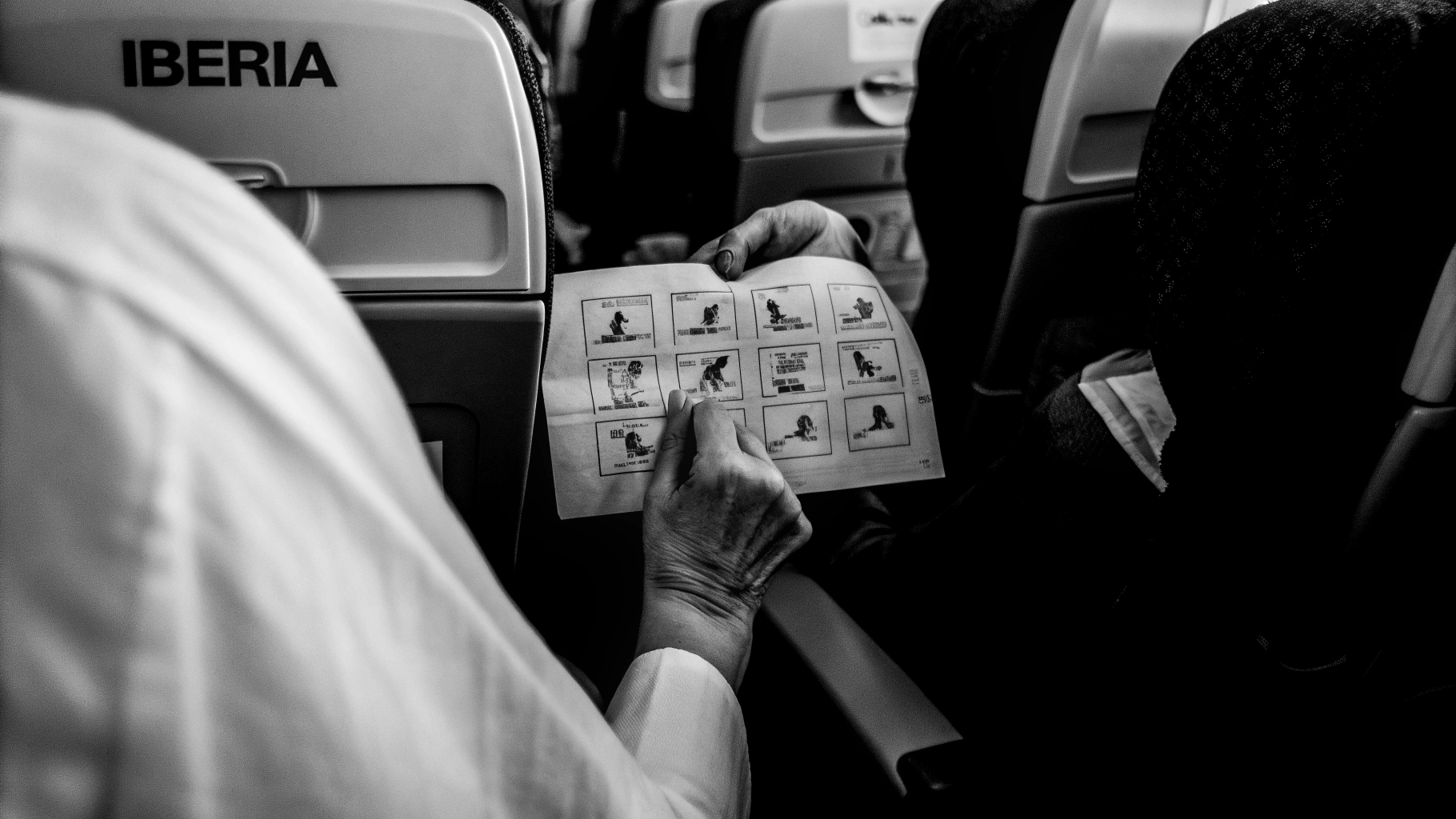AI generated image by Red Panda AI: A passenger on an Iberia flight from in its seat picks up the safety card. It’s not an ordinary safety guide, it’s actually a step-by-step tutorial for flamenco dance moves!