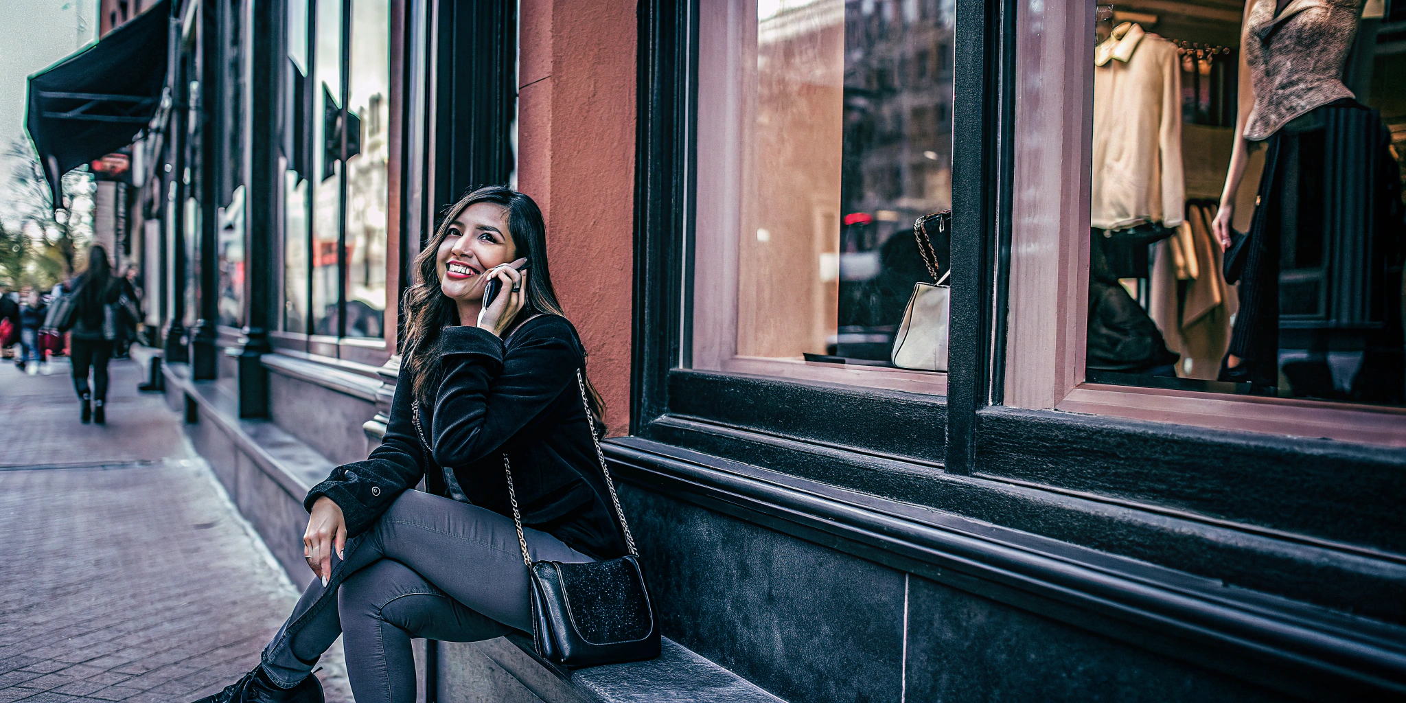 AI generated image by FLUX.1-schnell: Beautiful Latina, sitting outside a fancy clothing store, talking on her cellphone