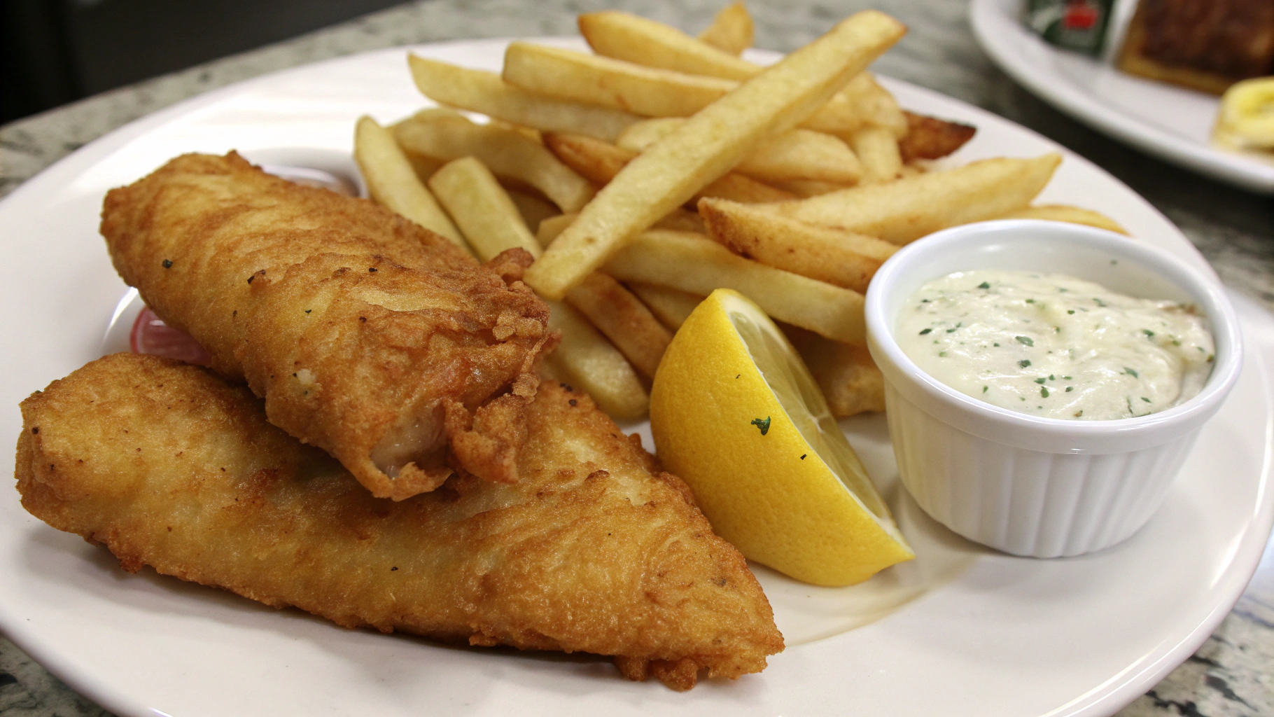 AI generated image by Red Panda AI: two pieces of fried fish, french fries, two lemon wedges, and a small cup of tarter sauce on a plate