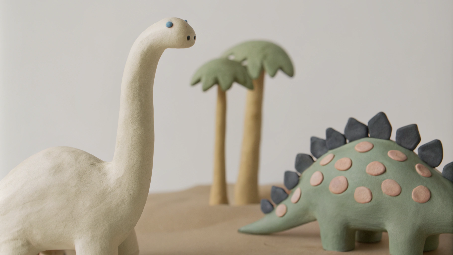 AI generated image by Red Panda AI: Two dinosaurs stand in the tropical rain forest. There are palm trees and blue sky on the right side of the background, and short shrubs and light blue distant mountains on the left side of the background. On the left is a dinosaur with a long neck and long tail. This dinosaur has a blue back, no dorsal fin, a yellow-green belly and four legs. On the right is a small dinosaur. There are white pointed dorsal fins on the back of the head and neck. There are 5 white dorsal fins. The entire back is light blue with dark blue spots, and the abdomen is beige. The dinosaur on the left is facing left as a whole, looking back at the dinosaur on the right. At this time, the tail of the dinosaur on the left is swinging forward. The dinosaur on the right is a close-up view, facing left. Disney style, children's comics.