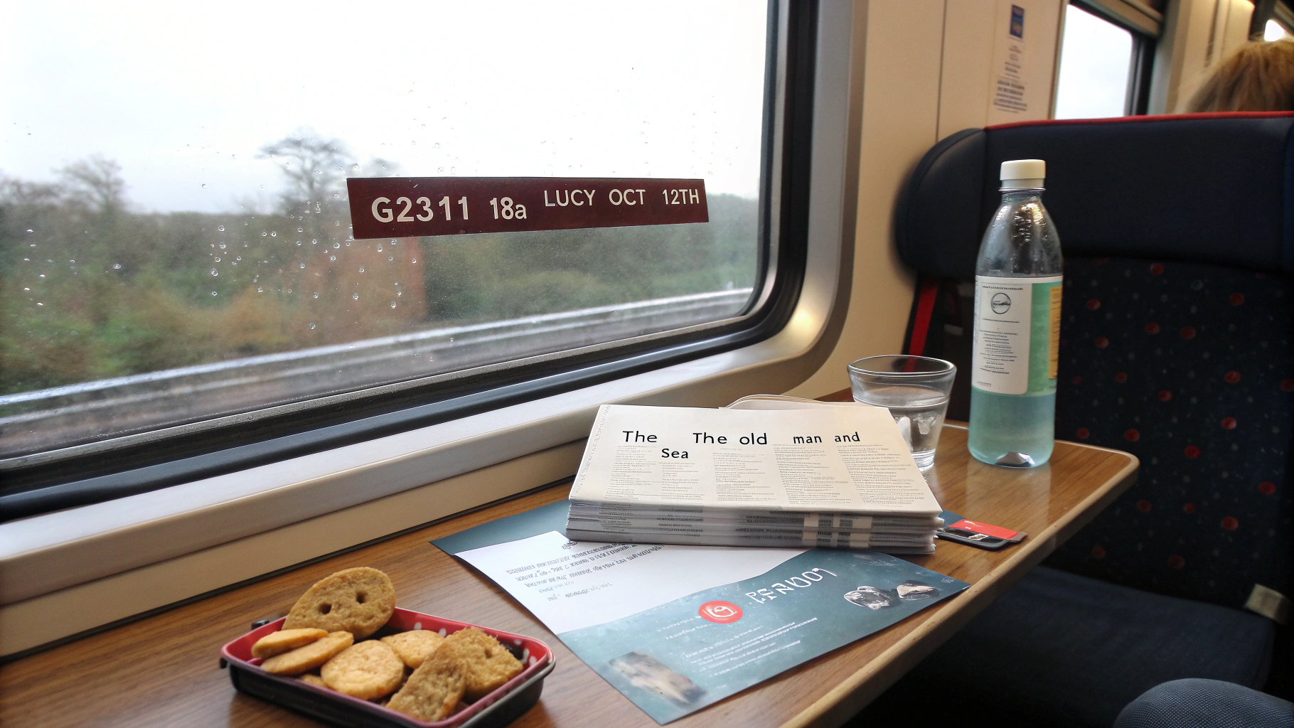 AI generated image by Red Panda AI: A train interior scene with a window seat where a train ticket is placed on the table. The ticket is clearly visible, showing the train number G2311, seat number 13A, passenger's name Lucy, and travel date Oct 12th. The ticket is placed next to the book The Old Man and the Sea, with some light snacks and a bottle of water on the table.