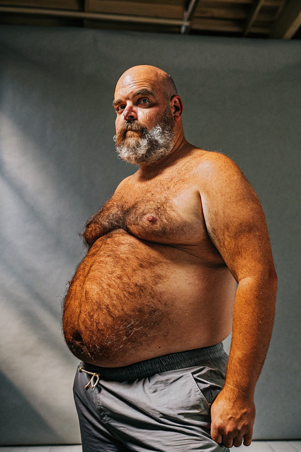 AI generated image by Red Panda AI: a studio photo of a slightly overweight 50 year old hirsute man. Man has heavy amount of body hair, hairy chest pattern, expanding his bloated heavy bearded-belly, bald head, brown and white goatee