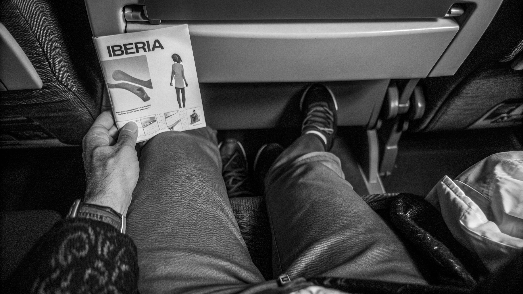 AI generated image by Red Panda AI: A passenger on an Iberia flight from their seat and picks up the safety card out of curiosity. As they open it, they’re surprised to find it’s not an ordinary safety guide—it’s actually a step-by-step tutorial for flamenco dance moves!