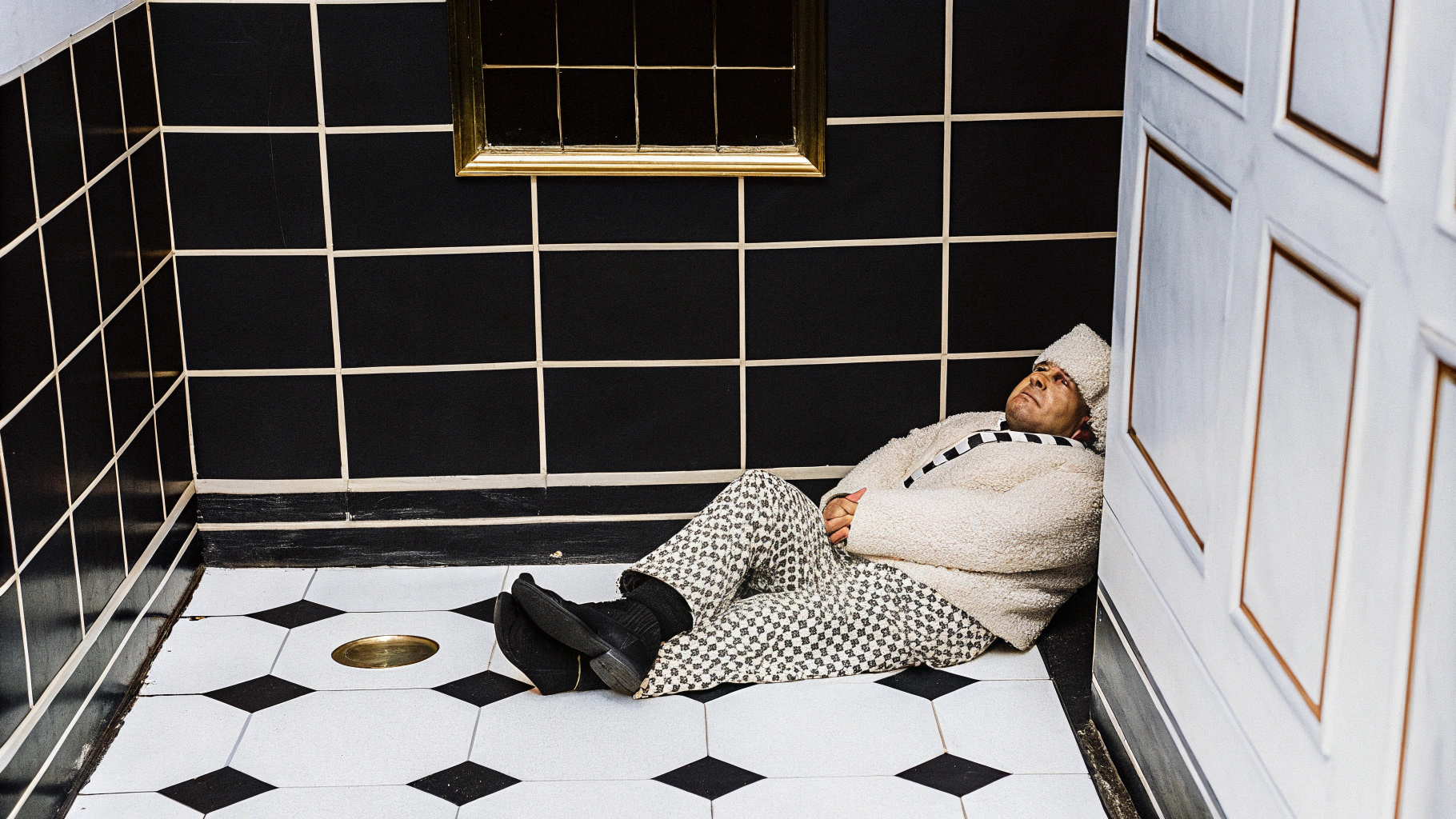 AI generated image by Red Panda AI: david lachapelle style photography, one middle aged chubby male dressed as a poddle lying on the floor, in a small square shaped pastel coloured toilet room without windows, 35 mm canon