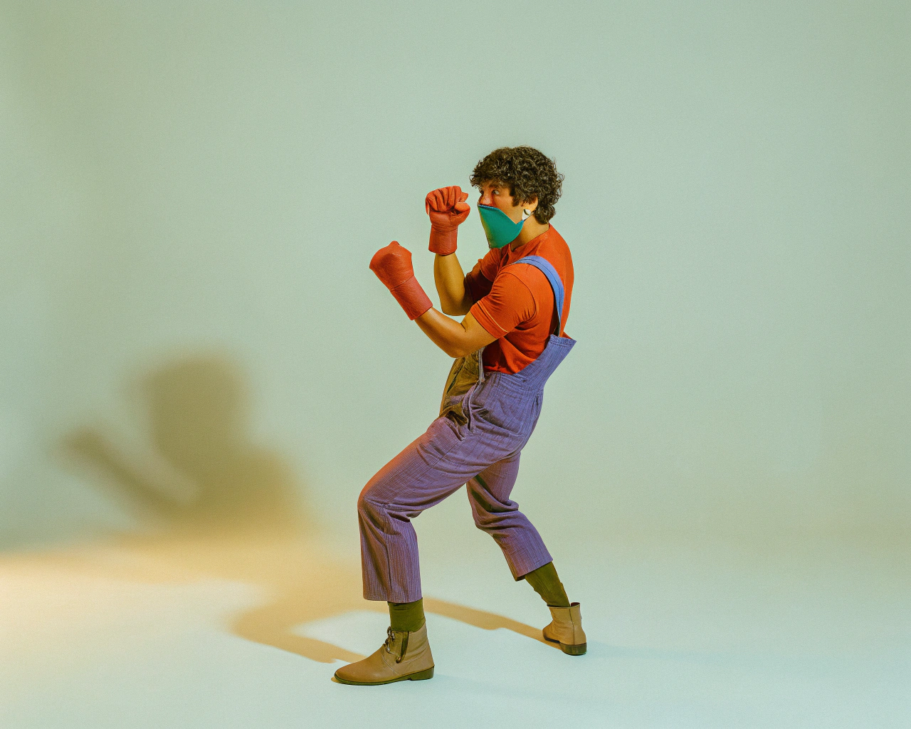 AI generated image by Red Panda AI: Real camera film photo of rural Cambodian man Man with stocking over his face, wearing a rubber suit on his arms and body with black curly hair, making a kung fu pose, holding a kung fu boxing pose. In sell pork market in Thailand
